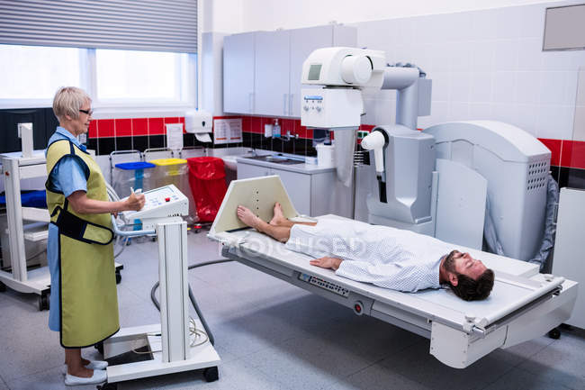 Male patient going through x-ray test in hospital — Stock Photo
