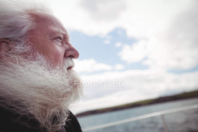 Close up of fisherman looking away from fishing boat — Stock Photo