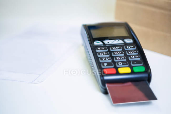 Payment terminal machine with credit card in shop — Stock Photo