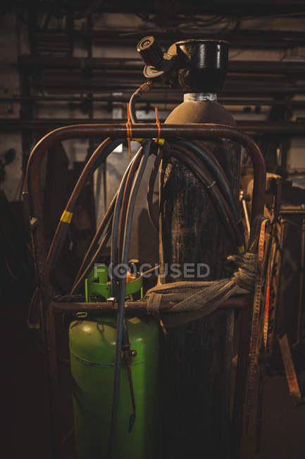 Close-up of blacksmith's gas, burner and cylinder at work shop — Stock Photo