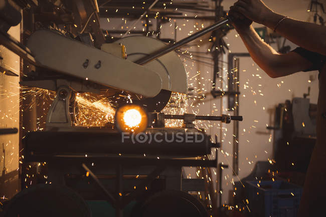 Blacksmith using circular saw machine in workshop — Stock Photo