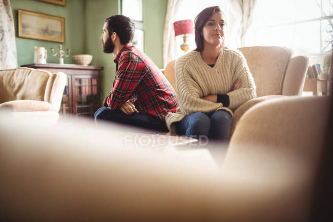 Couple ignoring each other in living room at home — Stock Photo