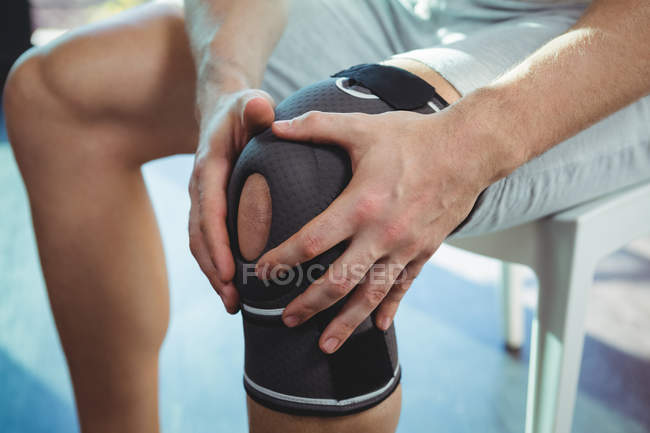 Обрізане зображення чоловіка з травмою коліна в клініці — стокове фото