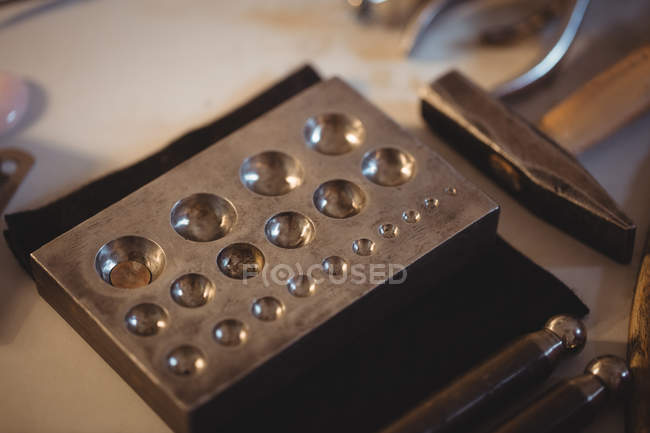 Close-up of steel doming block in workshop — Stock Photo