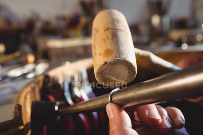 Cropped image of goldsmith preparing ring in workshop — Stock Photo