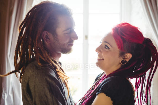 Romantic young hipster couple standing at home — Stock Photo