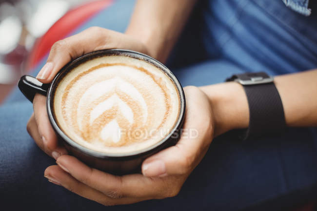 Midsection of woman with coffee at restaurant — Stock Photo