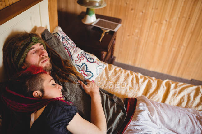 Blick aus der Vogelperspektive auf das junge Hipster-Paar, das zu Hause auf dem Bett schläft — Stockfoto