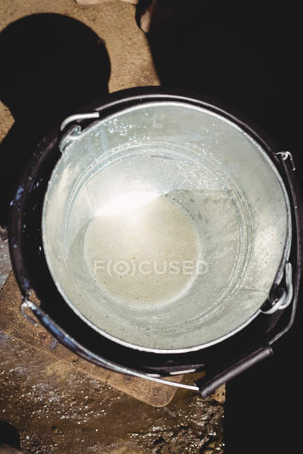 Close-up of empty steel bucket in barn — Stock Photo