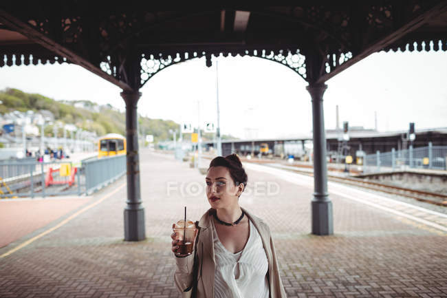 Mulher bonita de pé na plataforma estação ferroviária — Fotografia de Stock