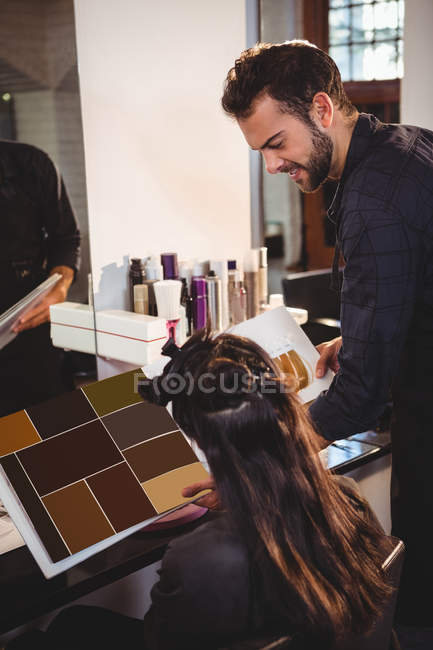 Donna che sceglie il colore di capelli con stilista a salone di capelli — Foto stock