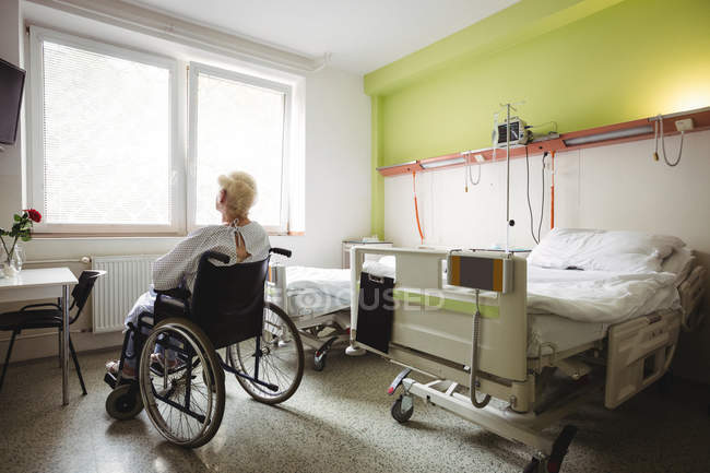 Senior woman sitting on wheelchair at hospital — Stock Photo