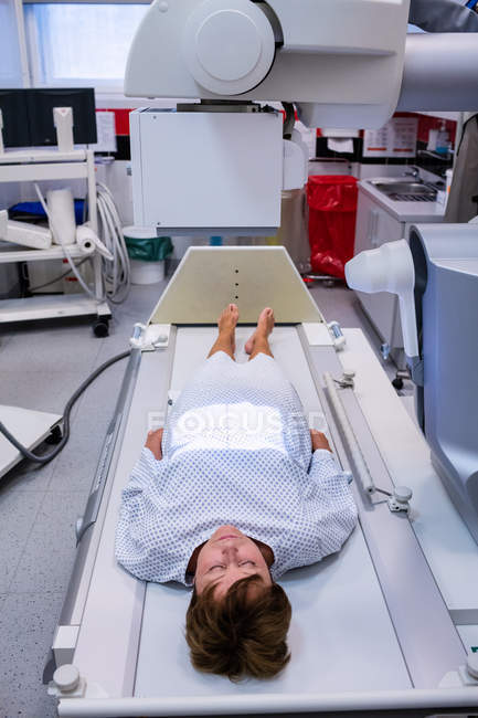 Female patient going through x-ray test in hospital — Stock Photo
