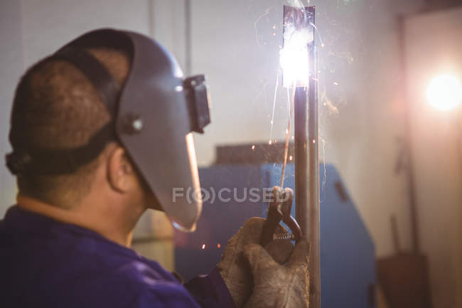 Welder welding metal in workshop — Stock Photo