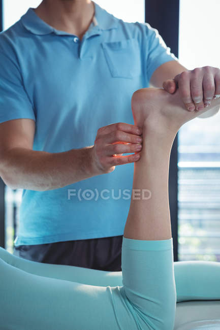 Cropped image of Male physiotherapist giving foot massage to female patient — Stock Photo
