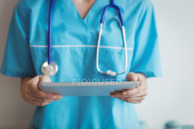 Середина медсестри з використанням цифрового планшета в лікарні — стокове фото