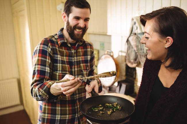 Mann füttert Frau in Küche zu Hause mit Lebensmitteln — Stockfoto