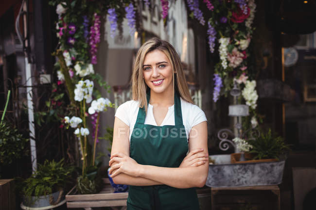 Portrait de fleuriste avec bras croisés dans sa boutique de fleurs — Photo de stock