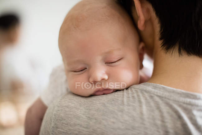 Mother carrying her baby at home — Stock Photo