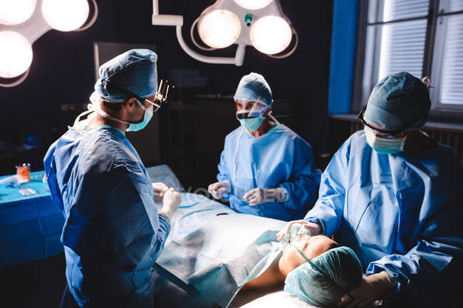 Surgeons performing operation in operation room at hospital — Stock Photo