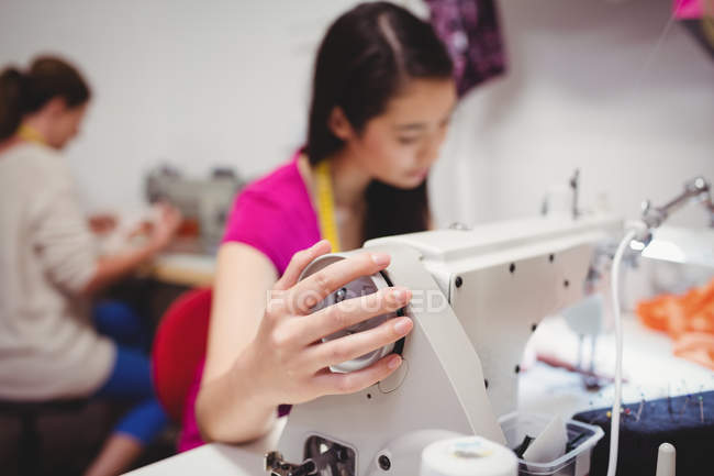 Female fashion designers working on laptop in studio — Stock Photo