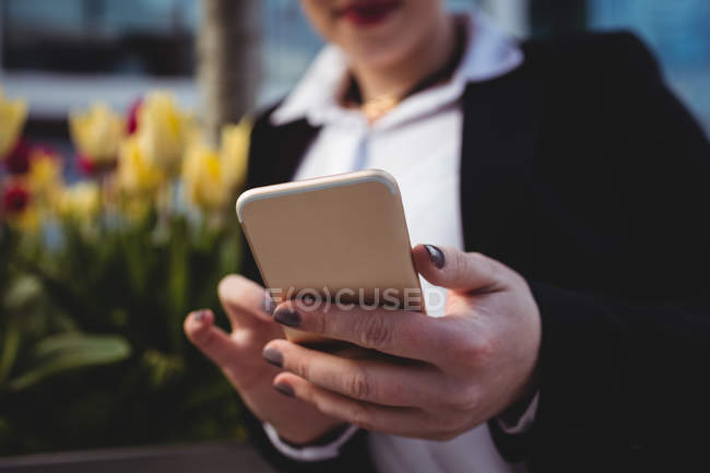 Close-up of businesswoman using mobile phone — Stock Photo