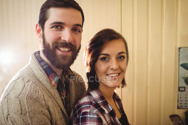 Retrato de casal sorrindo e olhando para a câmera em casa — Fotografia de Stock