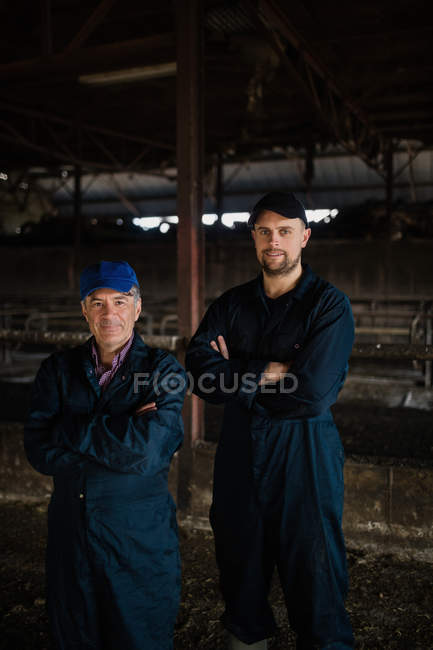 Portrait of smart coworkers standing in barn — Stock Photo