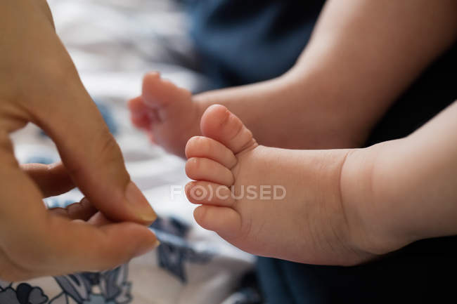 Cropped image of mother and baby in living room at home — Stock Photo
