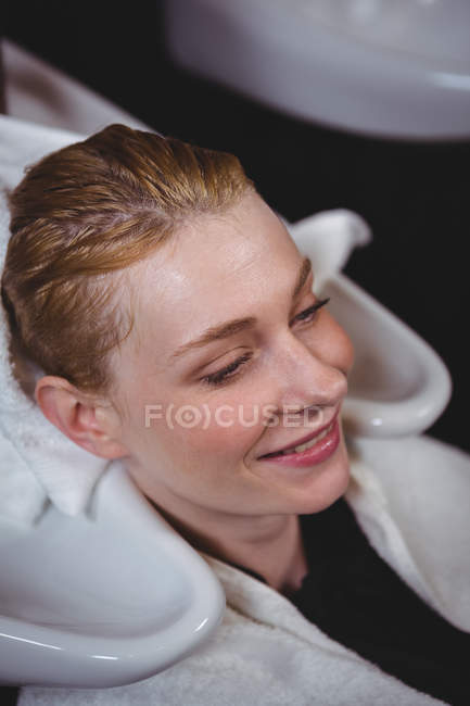 Стиліст волосся сушка жінка волосся з рушником в салоні — стокове фото