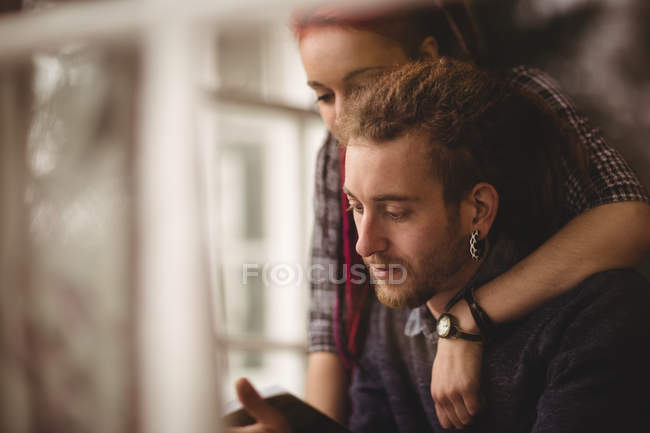 Close-up of young couple reading book at home — Stock Photo