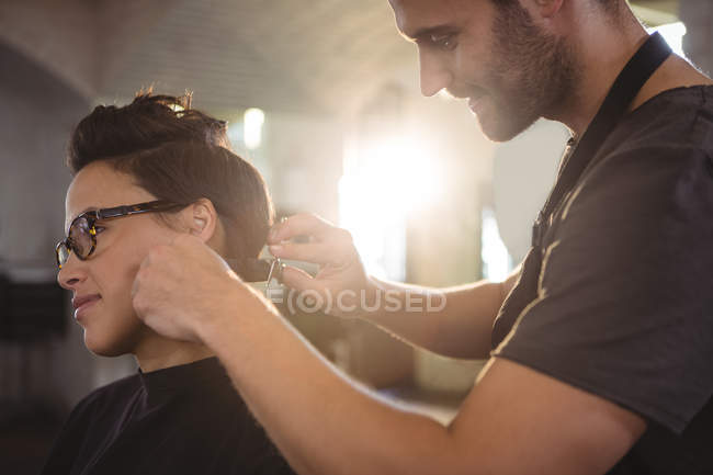 Frau lässt sich im Salon die Haare schneiden — Stockfoto