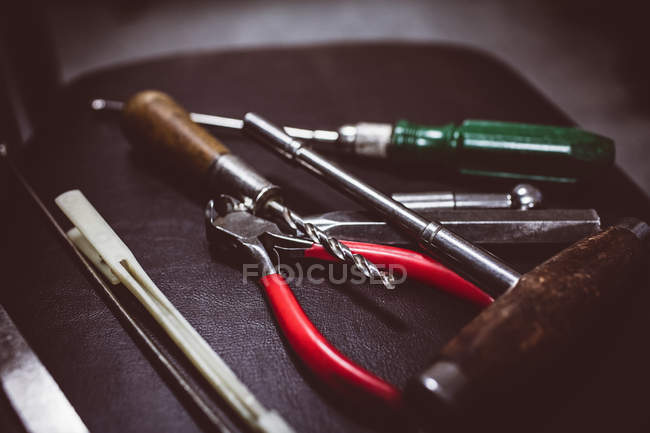 Close-up of piano repairing tools on bench at work shop — Stock Photo