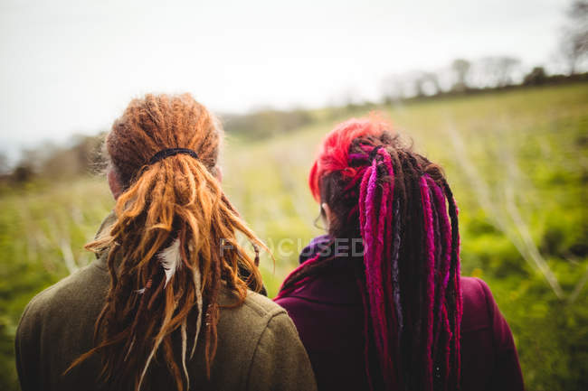 Vista da vicino posteriore della coppia di hipster in piedi al parco — Foto stock