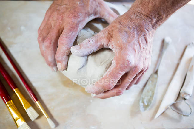Close-up potter molding clay in pottery workshop — Stock Photo