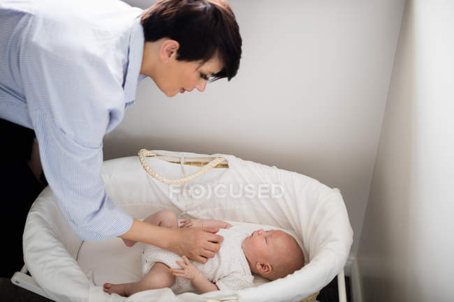 Mother looking at baby sleeping at home — Stock Photo