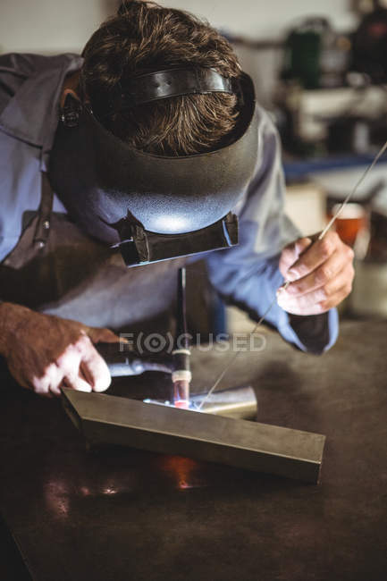 Welder welding metal in workshop — Stock Photo