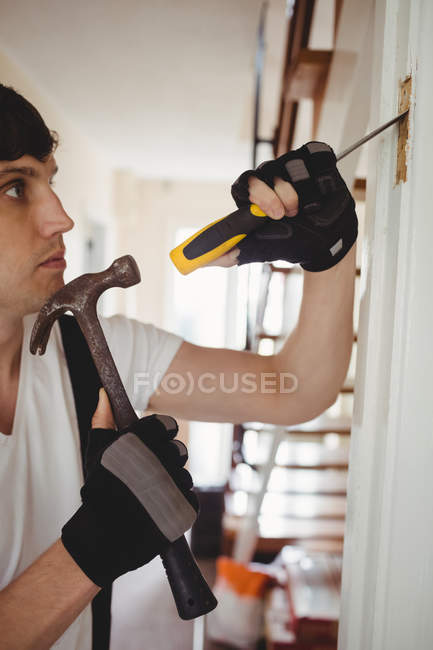 Carpenter working on door frame at home — Stock Photo