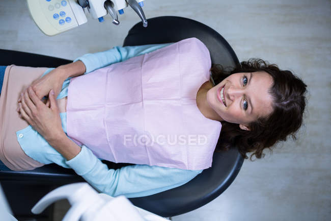 Dentist examining a patient with tools at dental clinic — Stock Photo