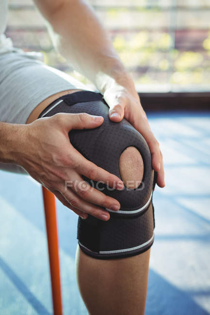 Imagen recortada de hombre con lesión de rodilla en la clínica - foto de stock