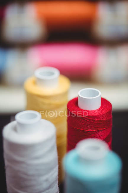 Close up of colorful spools of threads in studio — Stock Photo