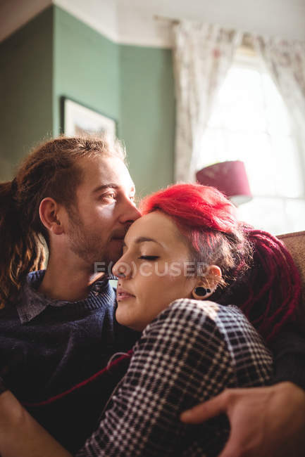 Romantic hipster couple embracing at home — Stock Photo