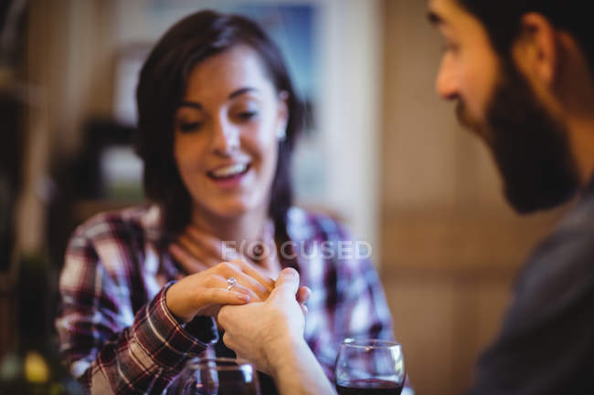 Man gifting finger ring to woman at home — Stock Photo