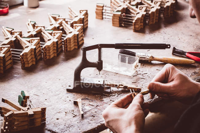 Piano technician working on piano parts at workshop — Stock Photo