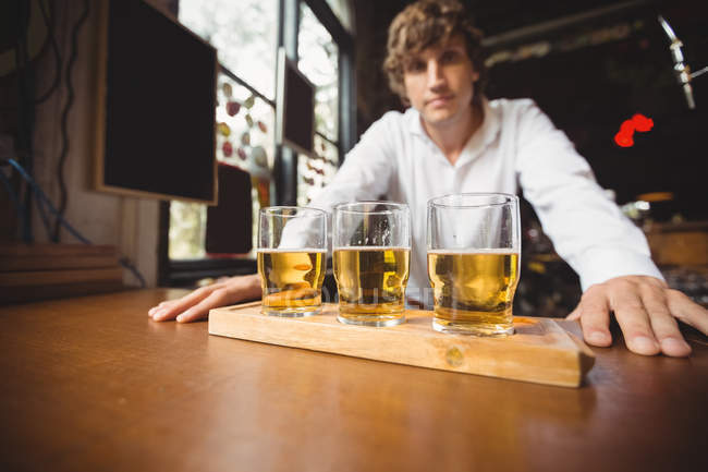 Portrait of bartender at bar counter in bar — Stock Photo