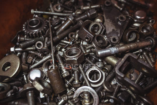 Close-up of various nuts and parts in workshop — Stock Photo