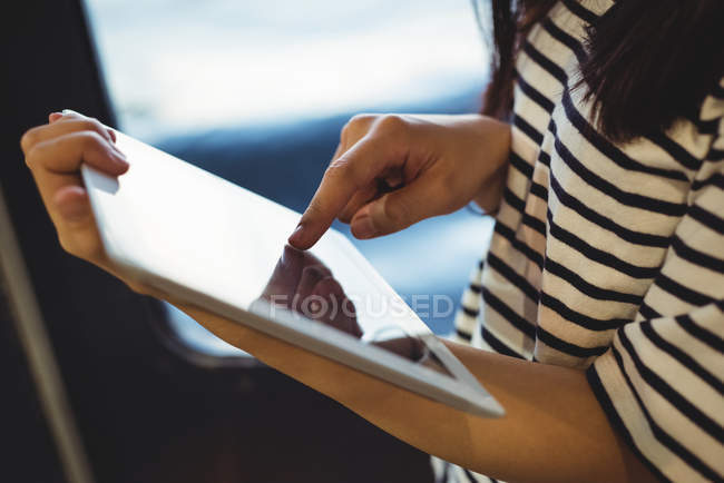 Mid section of woman using digital tablet — Stock Photo