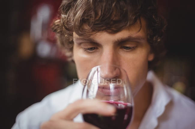 Man having a glass of red wine at bar — Stock Photo