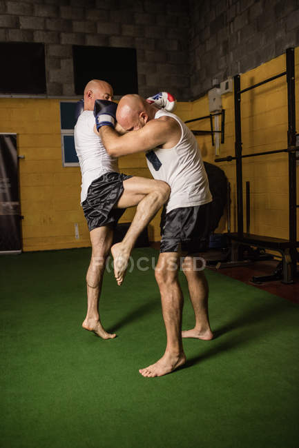 Strong Thai boxers practicing boxing in gym — Stock Photo