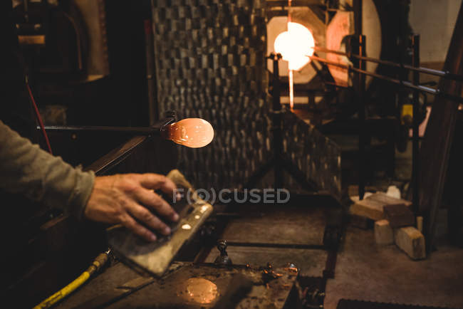 Ventilador que forma el vidrio fundido en la fábrica de soplado de vidrio - foto de stock